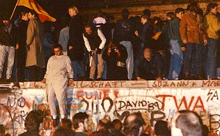 Protestors breach the Berlin Wall in 1989.