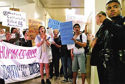 Students protest a speech given by former U.S. Rep Tom Tancredo.