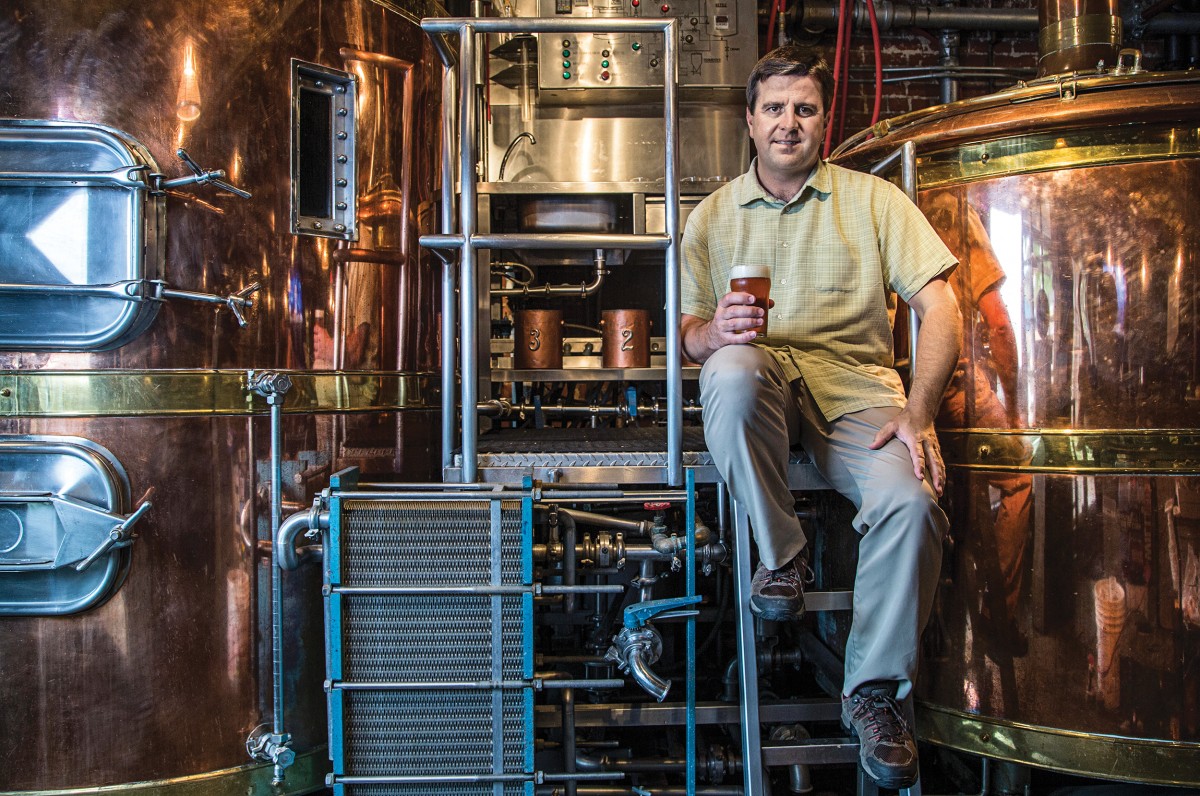 Robert Poitras ’94 of Carolina Brewery. Said to be the oldest in the Triangle, the brewery has been a Franklin Street staple since 1995, and it supplies beer to more than 1,000 bars and restaurants. Here, Blue Blood Rivalry Pilsner celebrates the enmity between the Tar Heels and Blue Devils. Photo by Travis Long