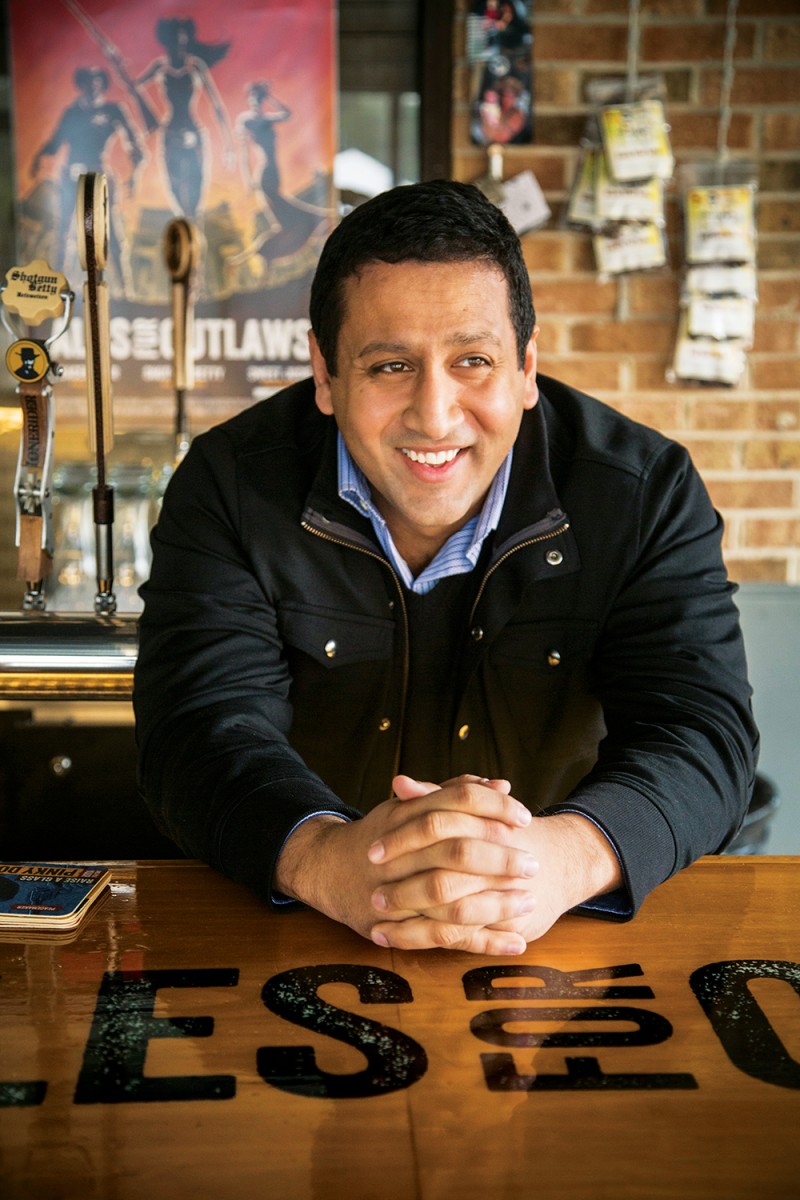 Sumit Vohra ’07 (MBA), “chief drinking officer” of Raleigh’s Lonerider Brewery. Here, nods to the shoot-’em-up outlaw flicks and spaghetti Westerns that inspired Vohra can be found in brews like the Belgian-style Beer With No Name and a stout called Pistols at Dawn. Photo by Travis Long