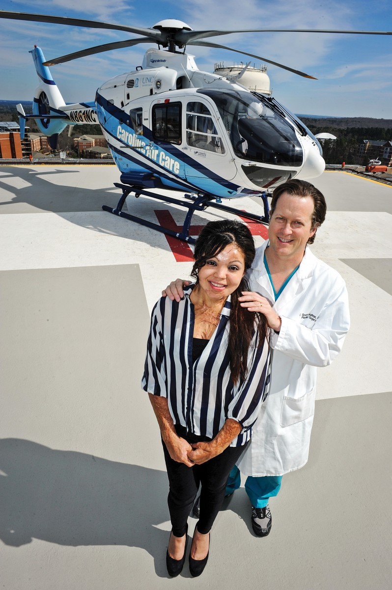 Cruz Maria Santibanez and Charles Hultman on the helipad at UNC Hospitals at the University of North Carolina at Chapel Hill.