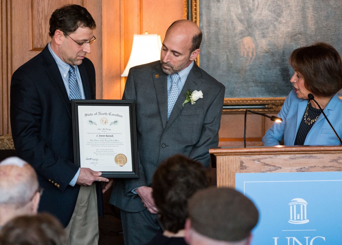 Reznick — who will retire in July — was inducted into the Order of the Long Leaf Pine by Chancellor Carol L. Folt and Daniel Gitterman, the Thomas Willis Lambeth Distinguished Chair in public policy who nominated Reznick for the award. (Photo by Mark Terry ’95)
