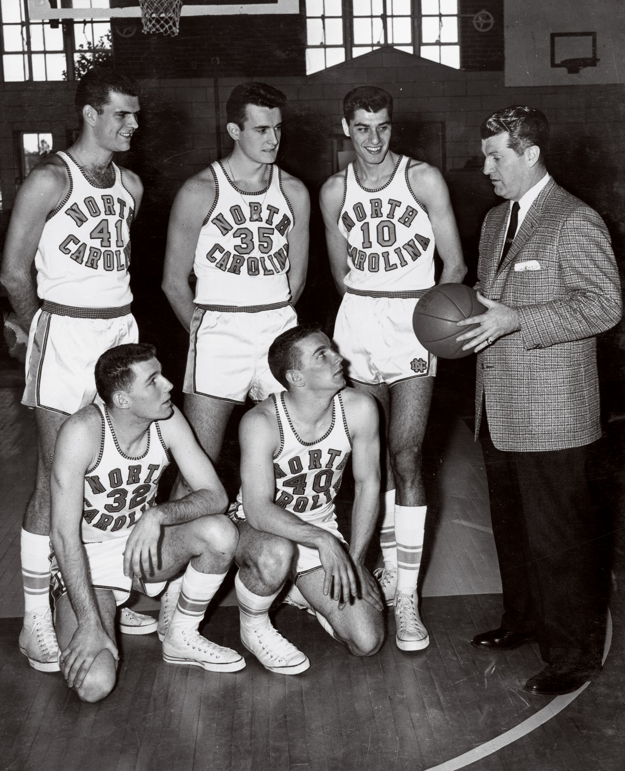 Coach Frank McGuire and his starters, from left: Joe Quigg ’57, Pete Brennan ’58 and Lennie Rosenbluth ’57; kneeling from left: Bob Cunningham ’58 and Tommy Kearns ’58. (UNC photo)