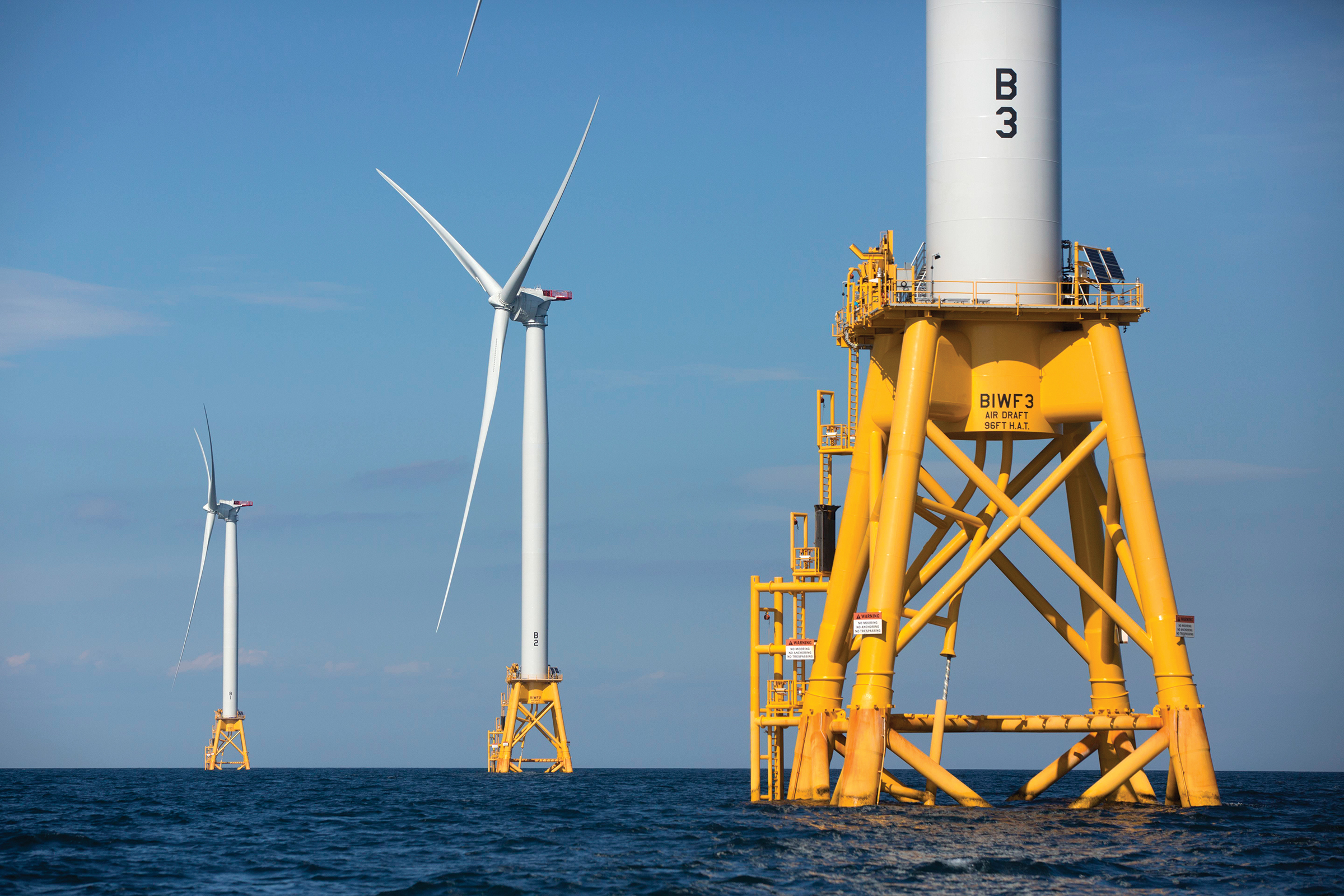 Three wind turbines from the Deepwater Wind project off Block Island, R.I., are viewed Monday, Aug. 15, 2016. Deepwater Wind's $300 million five-turbine wind farm off Block Island is expected to be operational this fall. (AP Photo/Michael Dwyer)